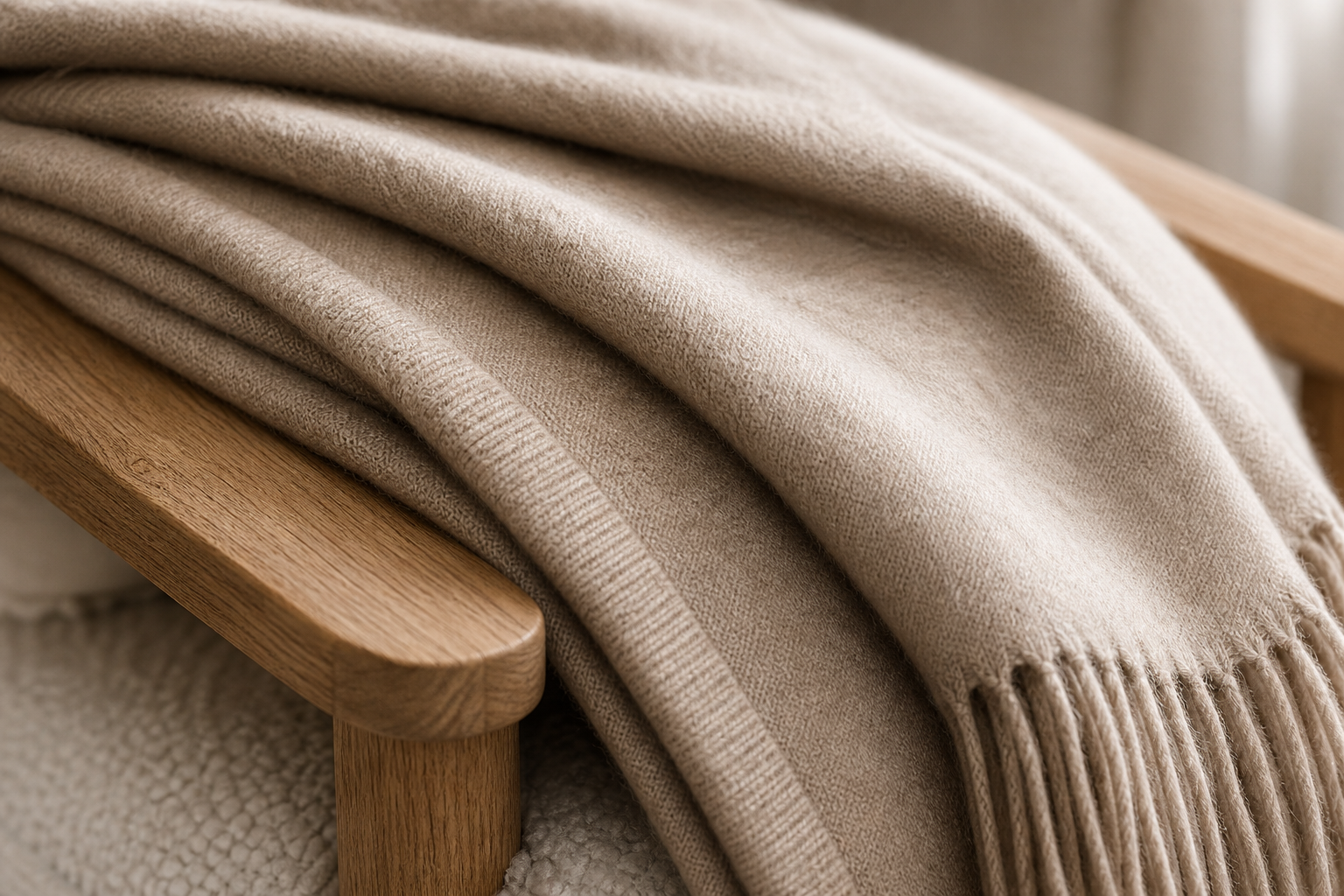 Close detail of oat cashmere throw fibres and folded edge
